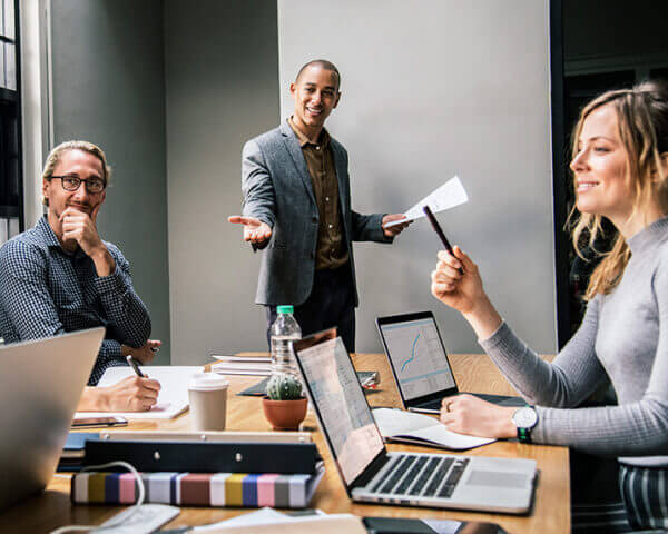Business team gathered around a conference table during a presentation